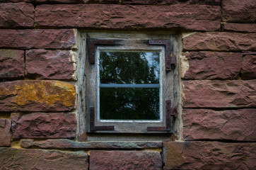 The wall and window of an old farmhouse