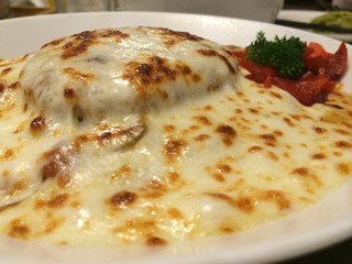 Stylist food, Close up homemade Japanese beef or pork curry severe with red radish and top with melt cheddar cheese on white plate in restaurant. healthy vegetarian food. Italian food concept