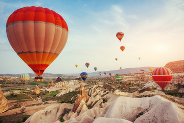 Colorful hot air balloons flying over Red valley at Cappadocia, 