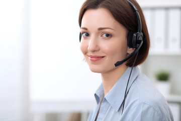  Young beautiful business woman in headset. Call center.