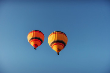 group of colorful hot air balloons against a blue sky