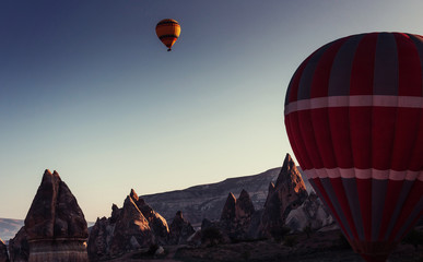 Amazing sunset over Cappadocia. Beautiful color balloons. Turkey