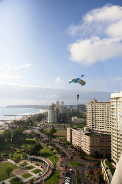 Man parachuting in city