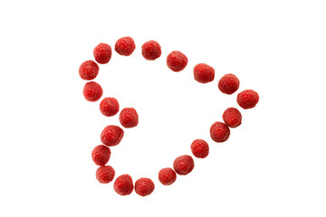 Ripe raspberries lying in a heart shape isolated in white