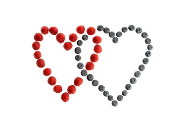 Fresh berries lying in two heart shapes isolated in white