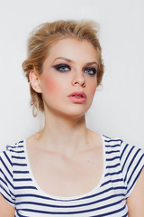 Pretty blonde girl portrait with smokey eyes wearing striped t-shirt