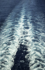 Wake of cruise ship in blue water