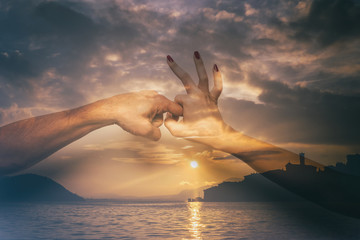 Double exposure of sex gesture and beautiful lake at sunset