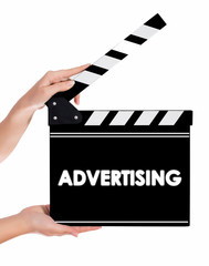 Obraz premium Hands holding a clapper board with ADVERTISING text