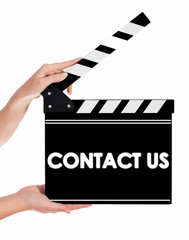 Hands holding a clapper board with CONTACT US text