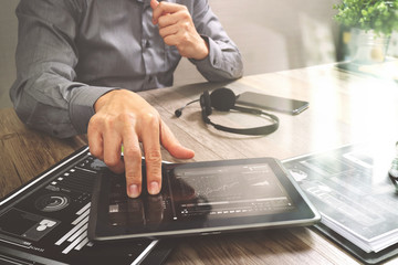 Businessman hand using VOIP headset with digital tablet computer,document,concept communication, it support, call center and customer service help desk
