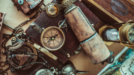 Antique compass old collection, compass necklace and telescope on a wooden treasure box in vintage...
