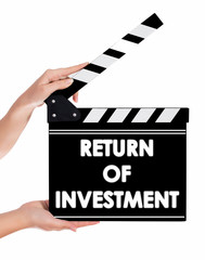 Hands holding a clapper board with RETURN OF INVESTMENT text