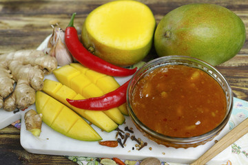 Bowl of homemade Mango Chutney on old wooden table