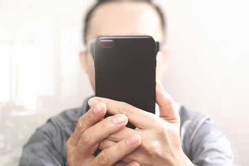 Designer hand using mobile payments online shopping,omni channel,customer network connection,wooden desk,icons graphic interface screen,eyeglass