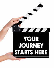 Hands holding a clapper board with YOUR JOURNEY STARTS HERE text