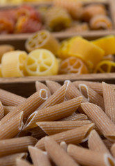 Variety of types, colors and shapes of Italian pasta. Dry pasta background