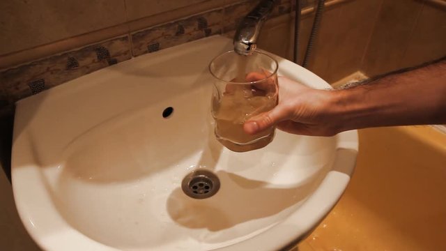 Faucet water runs in sink, starts out dirty rusty golden brown then turns clean