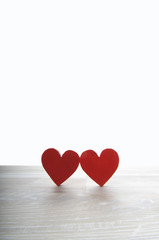 two hearts on white wooden background