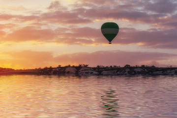 Composition of balloons over water and valleys, gorges, hills, b