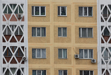 Fototapeta premium Vintage background wall with windows of a multistory building