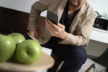 man hand using VOIP headset with digital tablet computer docking keyboard,smart phone,concept communication, it support, call center and customer service help desk,London architecture city