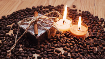 Burning aromatic coffee candle and beans, close-up