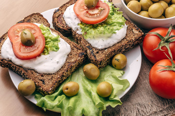 Vegetarian Sandwiches of homemade bread with cheese sauce or cream, lettuce