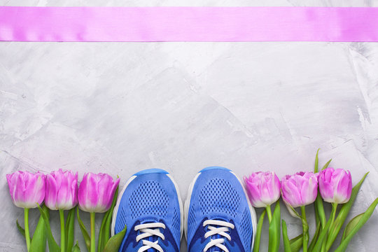 Spring flatlay composition with sneakers and tulips.