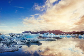 Icebergs in the glacial lake with a mountain