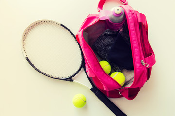 close up of tennis stuff and female sports bag