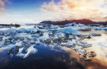 Icebergs in the glacial lake with a mountain