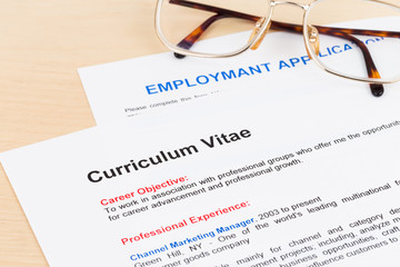 Curriculum vitae and employment application form with glasses
