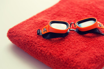 close up of swimming goggles and towel