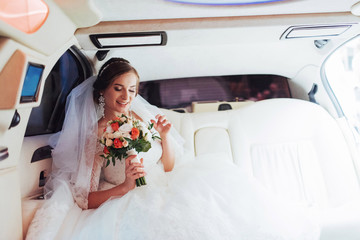 Portrait of a beautiful young bride in the car 