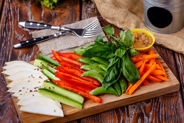 Sliced veggies (celery, carrots, peppers, cucumbers) are on the Board.