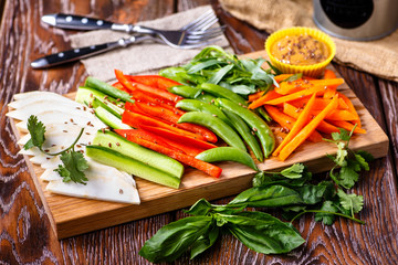 Sliced veggies (celery, carrots, peppers, cucumbers) are on the Board.