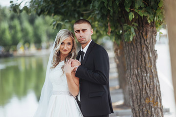 Happy young couple poses for photographers on her happiest day. 