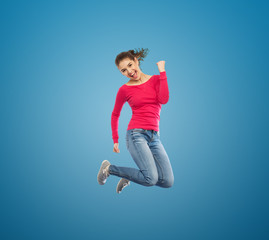 Obraz premium smiling young woman jumping in air