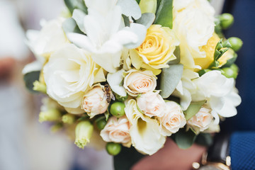 wedding bouquet in hands of the groom
