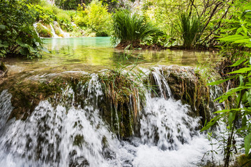 Fototapeta na wymiar Cascades waterfalls, among the green grass. Plitvice, National Park, Croatia