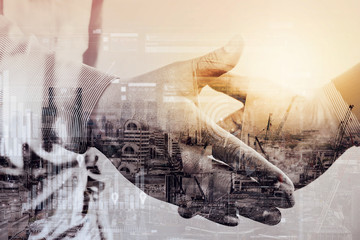Double exposure of Business partnership meeting concept.photo businessmans handshake. Successful...
