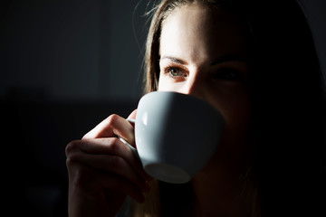 Young woman with cup of hot drink