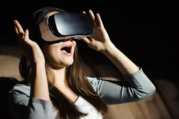 Young woman experiencing virtual reality glasses