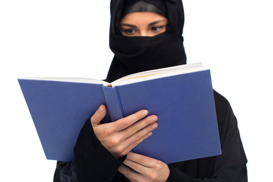 muslim woman in hijab reading book over white