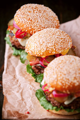 a delicious and juicy burger home in a rustic style with a big chop of beef