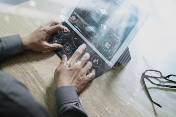 Designer Businessman hand using smart phone,mobile payments online shopping,omni channel,digital tablet docking keyboard computer in modern office on wooden desk,virtual interface icons screen