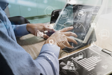 Designer Businessman hand using smart phone,mobile payments online shopping,omni channel,digital tablet docking keyboard computer in modern office on wooden desk,virtual interface icons screen