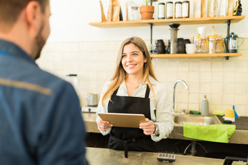 Pretty female barista taking an order