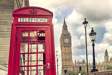 Fototapeta na wymiar London - Big Ben tower and a red phone booth. Vintage film effect. Instagram filter